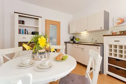 Wohnzimmer mit Esstisch und Küchenzeile