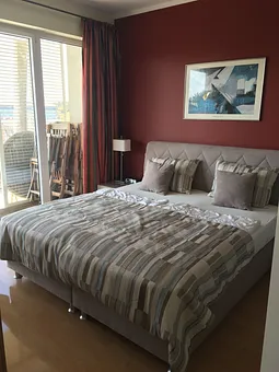 Ein gemütliches Schlafzimmer lädt zur Entspannung ein. Ein transportabeles Kinderbett ist vorhanden. 