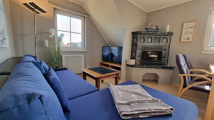 Blick ins Wohnzimmer mit Couch und 43" LED Fernseher