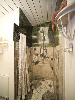 In Marmor gefasster, ebenerdiger Duschbereich mit Regenschauerdusche