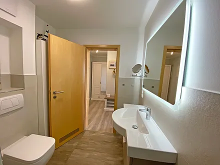 Badezimmer mit Dusche,WC, Kosmetikspiegel und Fön