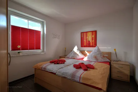 Schlafzimmer mit Doppelbett und großem Kleiderschrank. Die Erstausstattung mit Bettwäsche ist inklusive. 