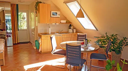 vollst. ausgest. Küchenzeile mit Kühlschrank, 2-Platten Ceran-Kochfeld, Mikrowelle, Kaffeemasch., Toaster und Küchenradio, der Essbereich mit ausziehbarem Tisch bietet ausreichend Platz für 4-6 Pers.