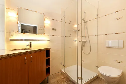 Hier ein Blick in das schöne Bad mit Echtglasdusche und großem Waschtisch. 