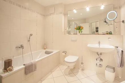 Das große Badezimmer hat Badewanne, WC, Fön und Dusche.