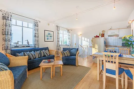 Sitzbereich und Esstisch und Küche im Hintergrund