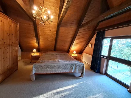 Schlafzimmer mit Doppelbett und Panoramafenster