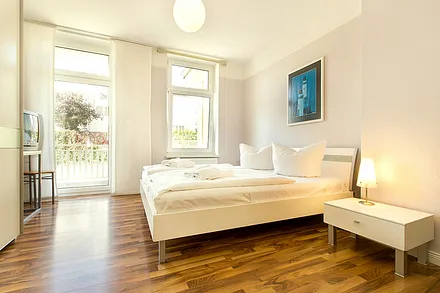 Hier der Blick in das große Schlafzimmer mit TV, Kleiderschrank  und Austritt zum Balkon.