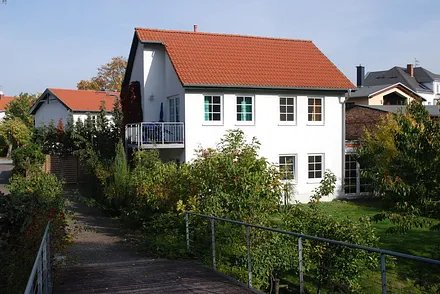 Ferienhaus von Süden, oben ist links und rechts jeweils ein Balkon