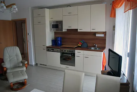 komplett ausgestattete Küchenzeile mit Kochherd, Mikrowelle und Geschirrspüler