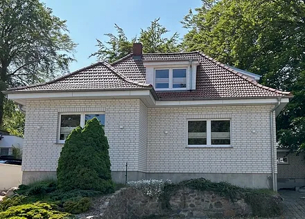 Hausansicht mit Parkplätzen