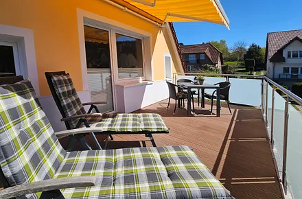 Sonnenliegen und Terrassentisch mit Bestuhlung laden zum Entspannen ein