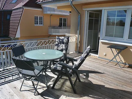 große Dachterrasse mit Möbeln (zusätzl. 2. überdachter Balkon mit Möbeln hinten - nicht sichtbar)