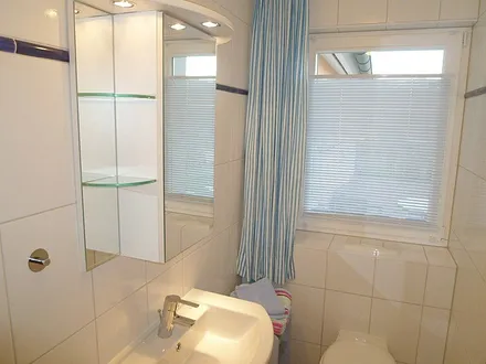 Modernes Bad mit flacher Dusche und WC