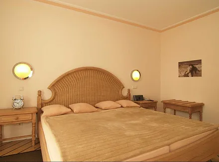 Schlafzimmer mit großem Doppelbett…