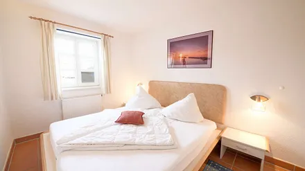 Das Schlafzimmer mit Doppelbett und im Sommerhalbjahr mit Insektenschutzfenstern.