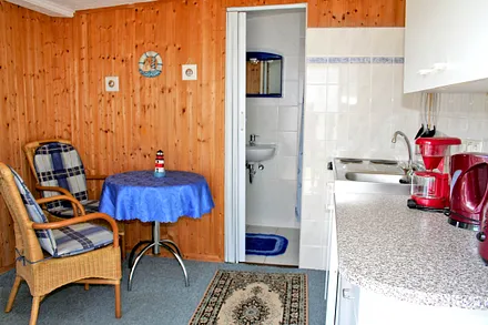 Wohnbereich mit Sitzecke und Zugang zum Bad