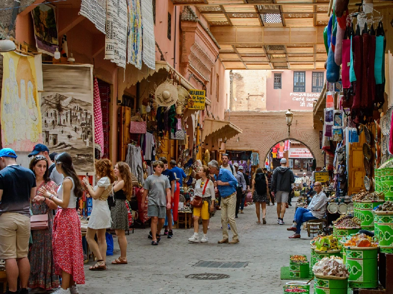 Tourists explore Marrakech souks.