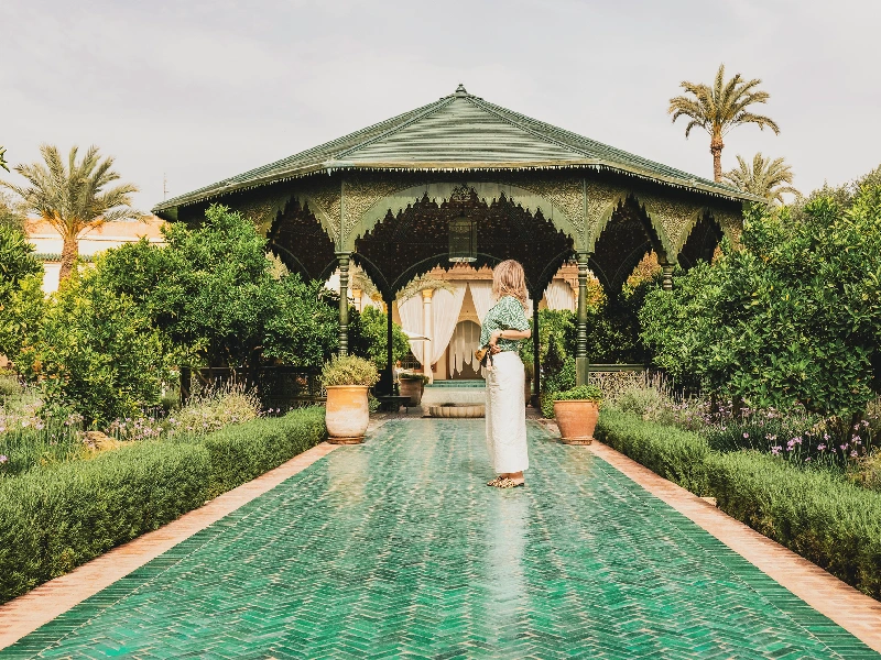 Woman strolling through a lush garden in Marrakech