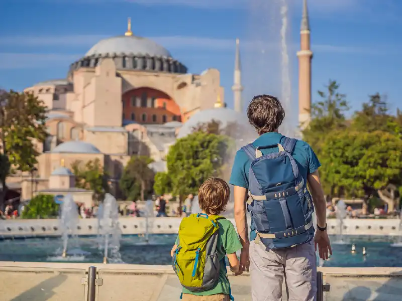A father and son stand admiring the grandeur of the Hagia Sophia.