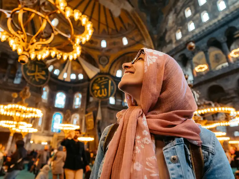 Woman admiring Hagia Sophia's interior.