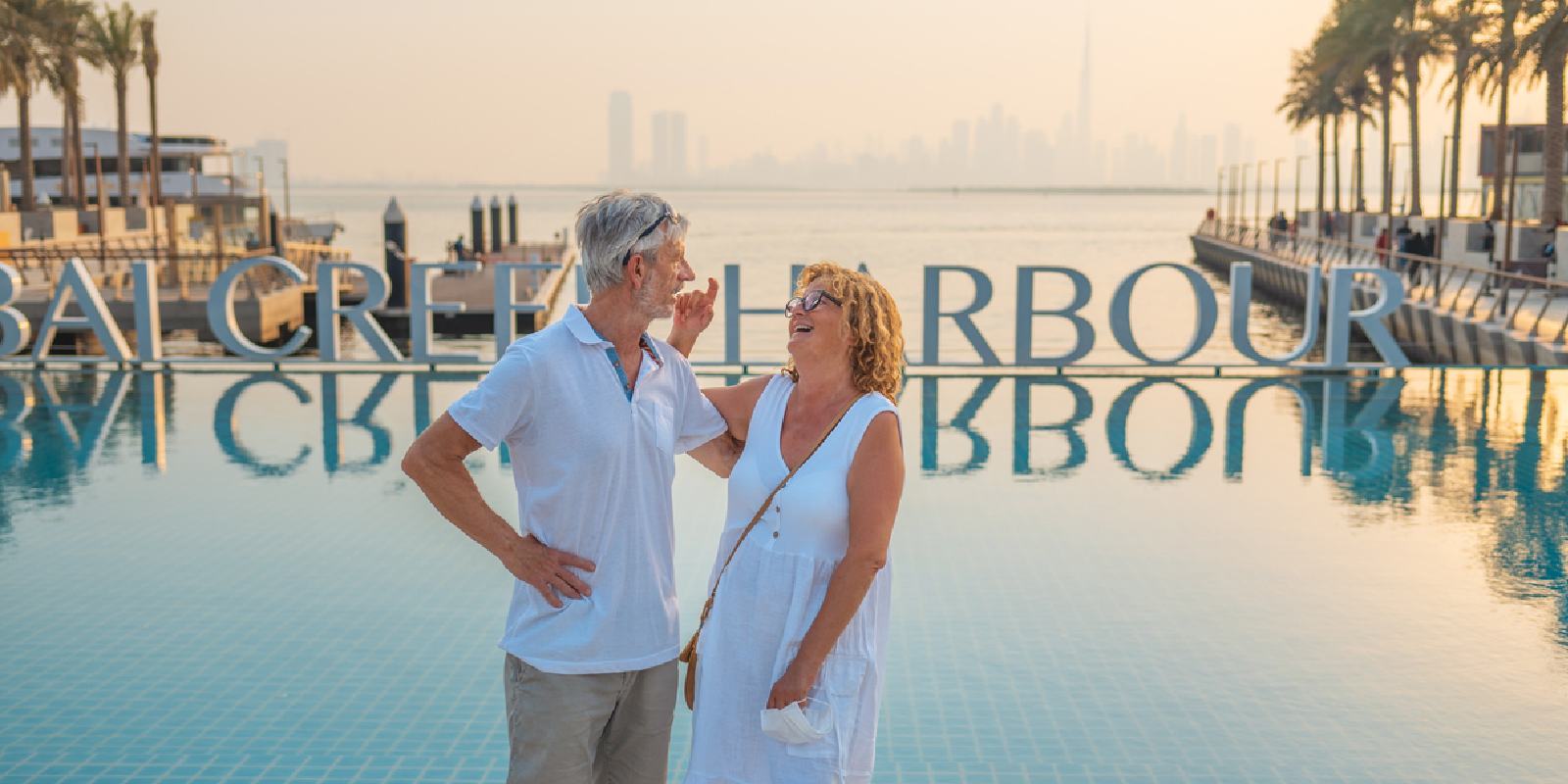 A couple enjoys the sunset and skyline at Dubai Creek Harbour.