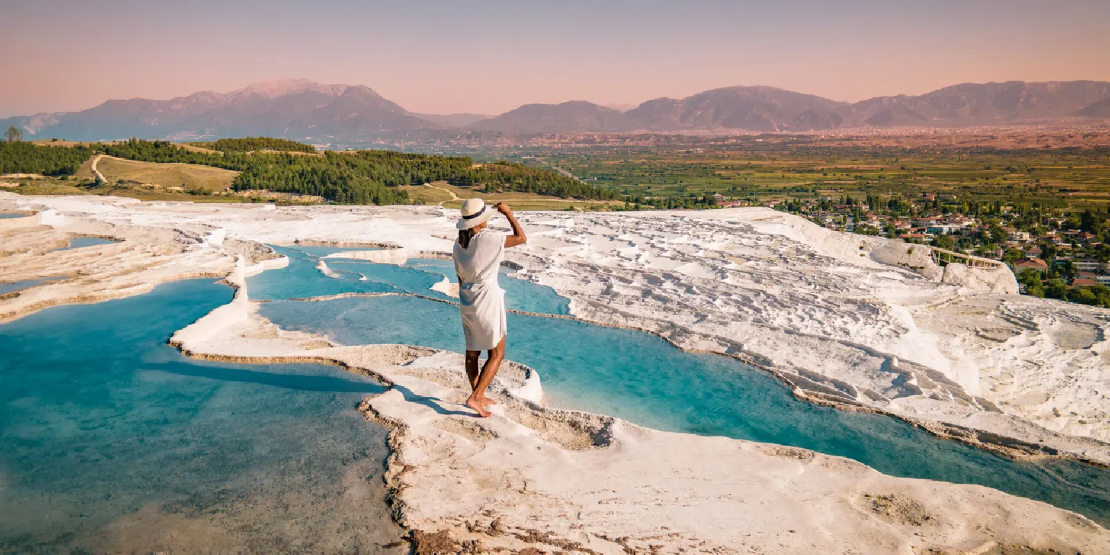 Girl in white outfit enjoying Pamukkale pools.
