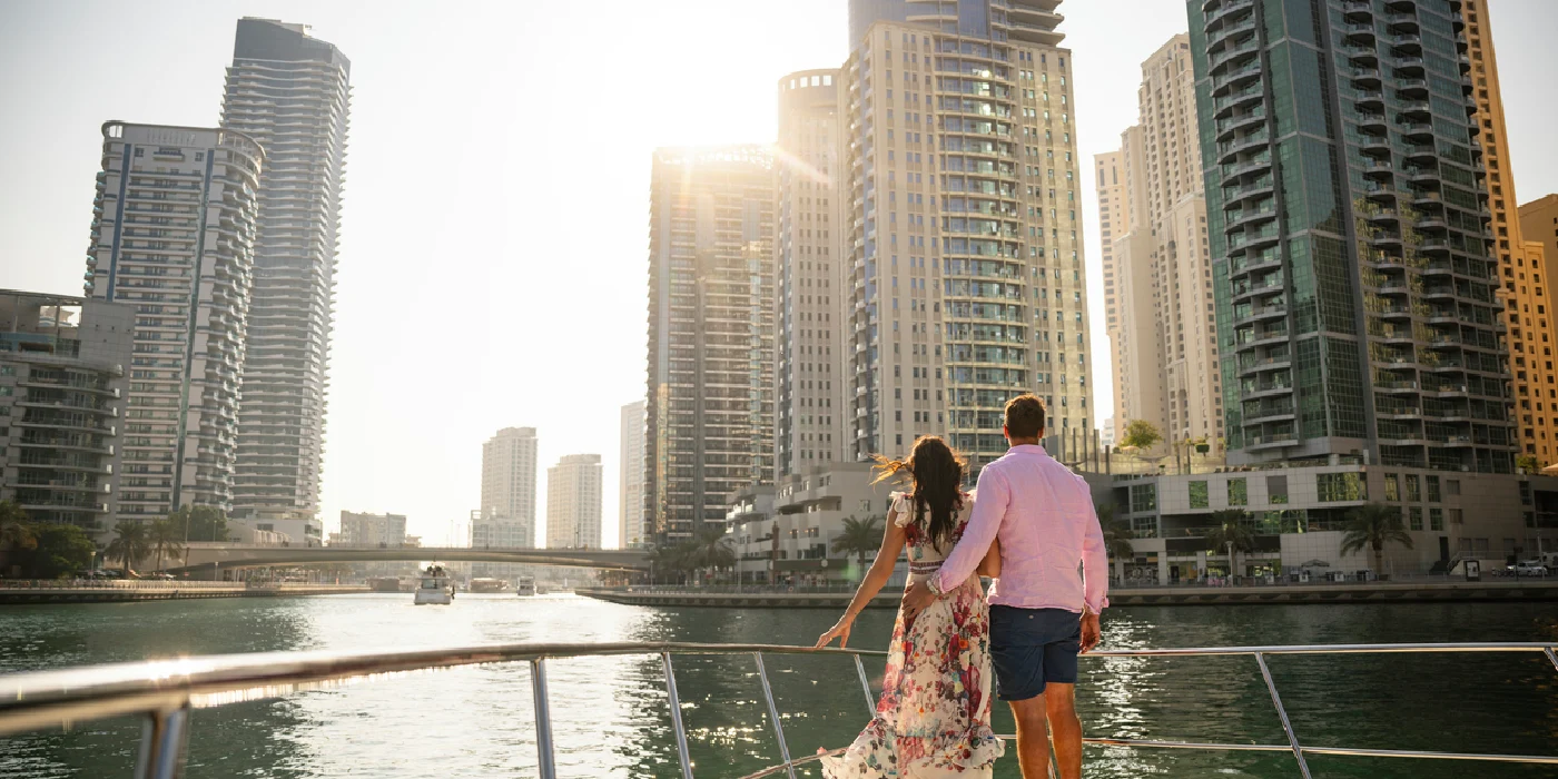 Couple in UAE watching Dubai Marina at sunset.