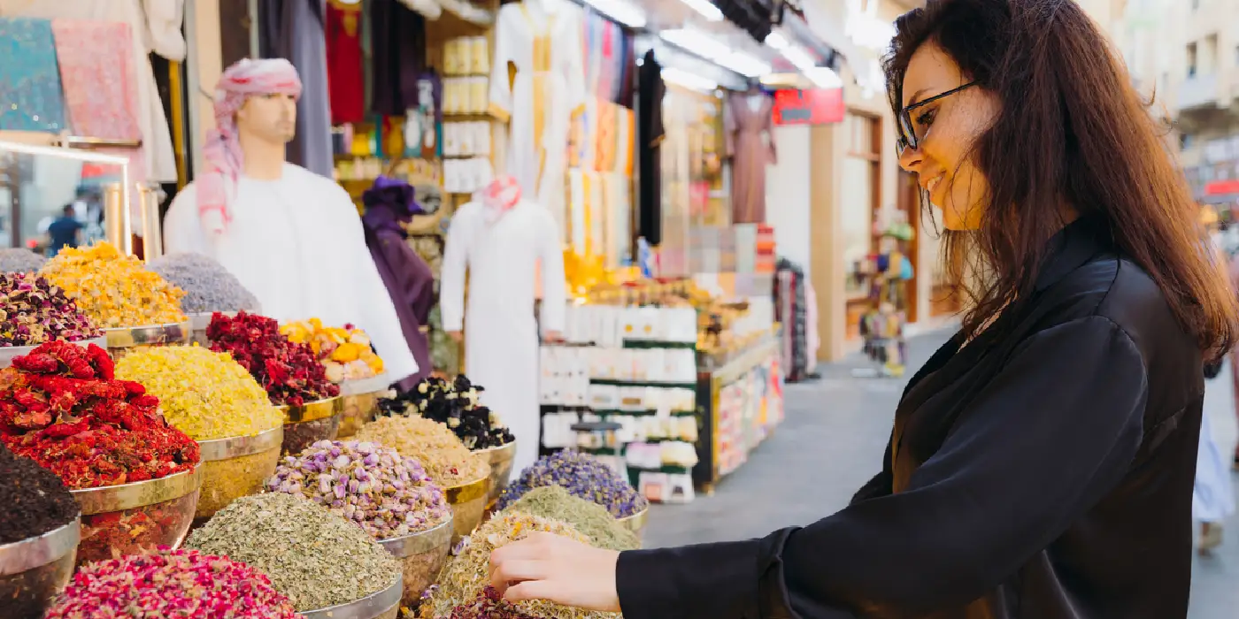 Woman walking through Dubai spice market.