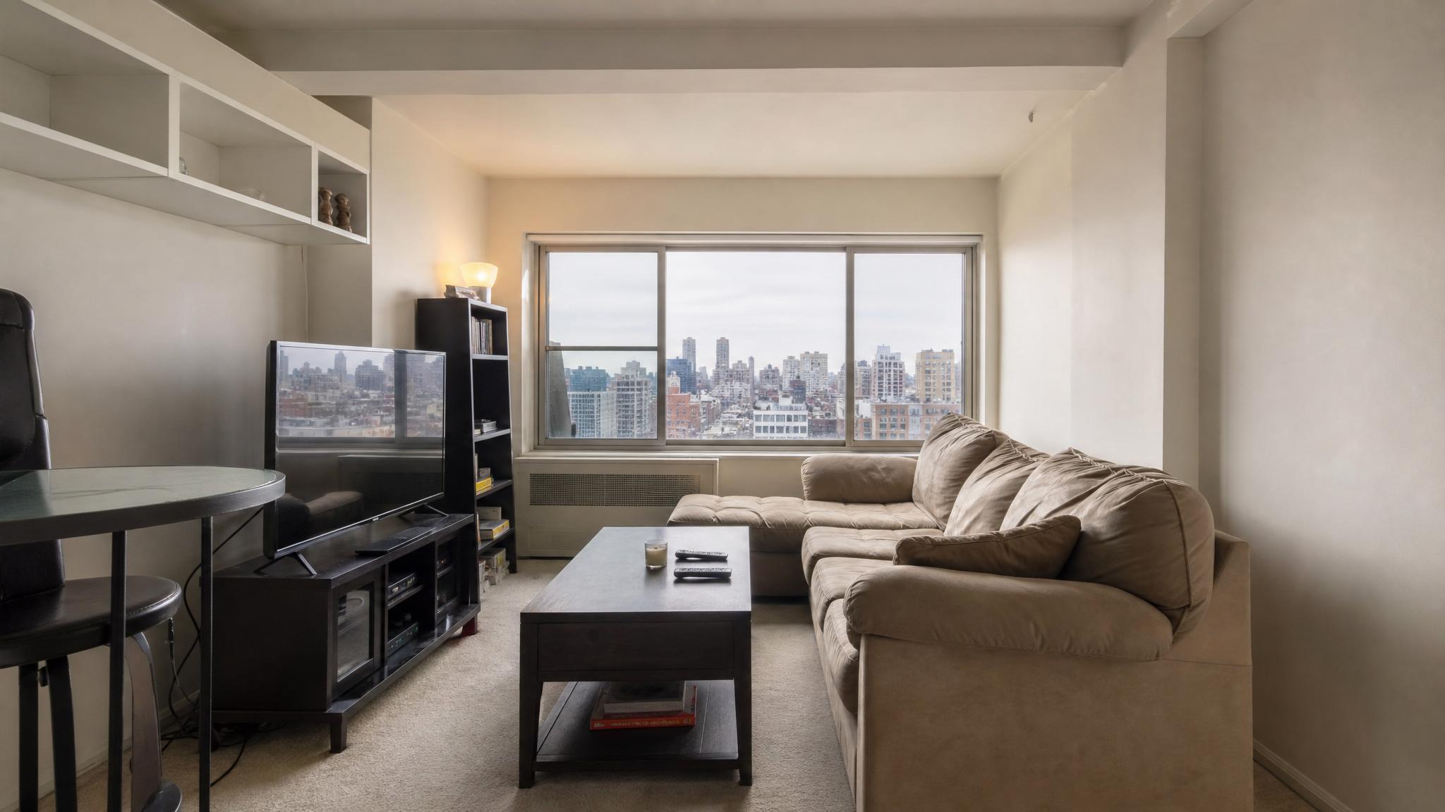 Before - cramped small living room in a penthouse apartment before renovation.
