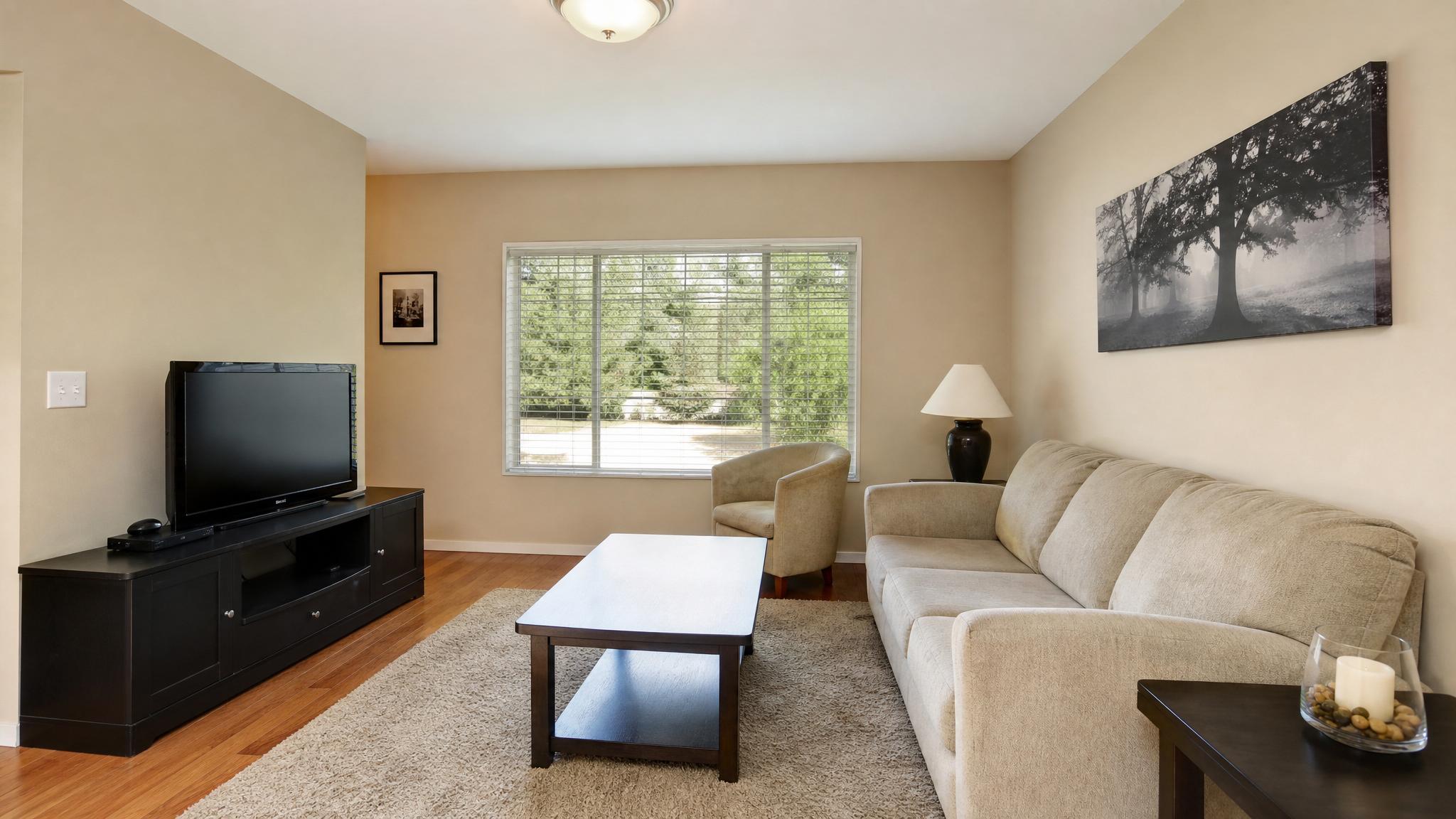 Before makeover: a small living room with bland decor and limited natural elements.