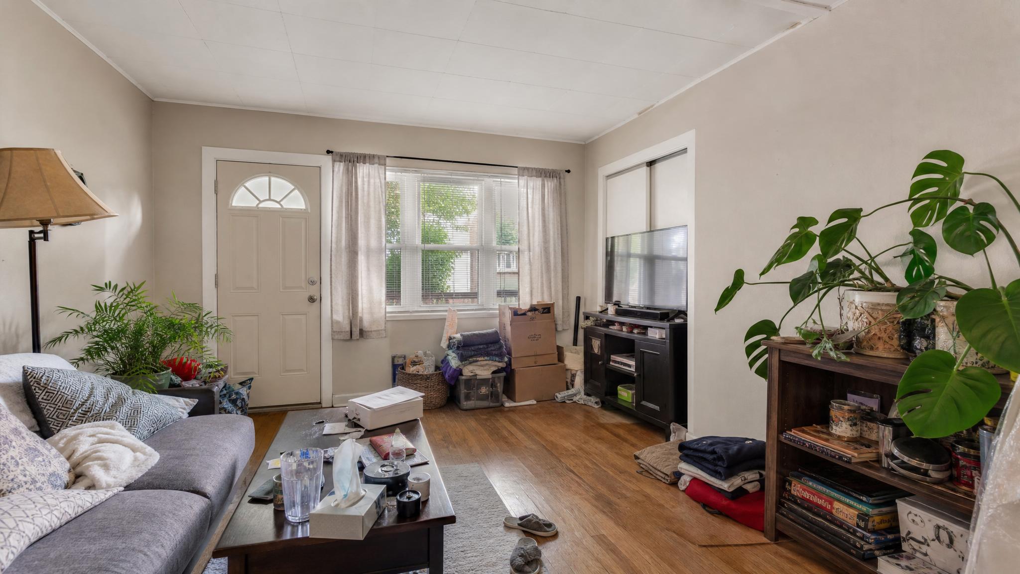 A cluttered small living room before staging