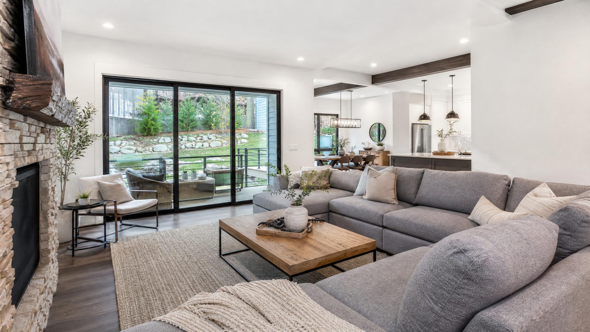 A living room designed with soft white walls and cool gray furniture
