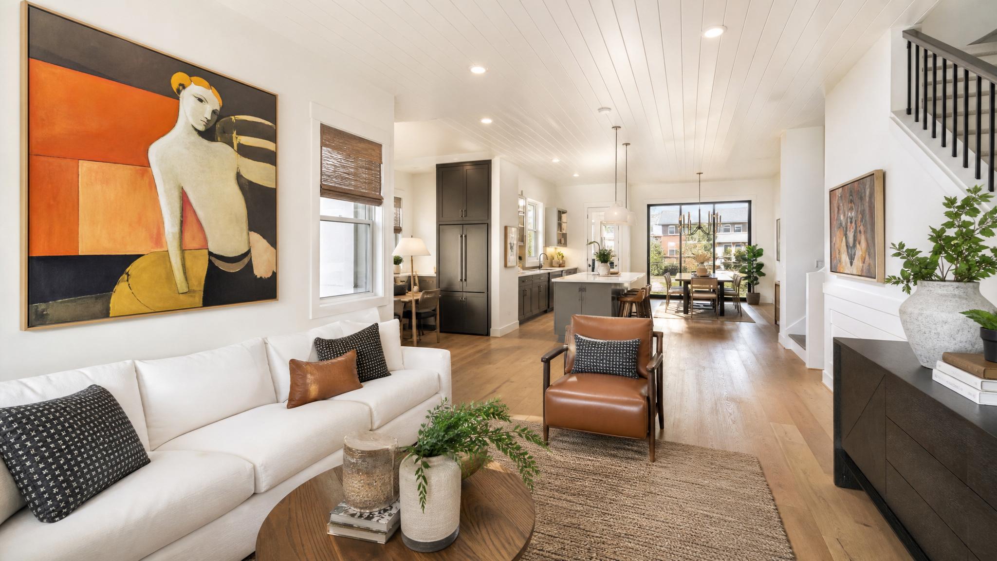 Vibrant open-plan living room showcasing artistic wall decor and stylish furniture