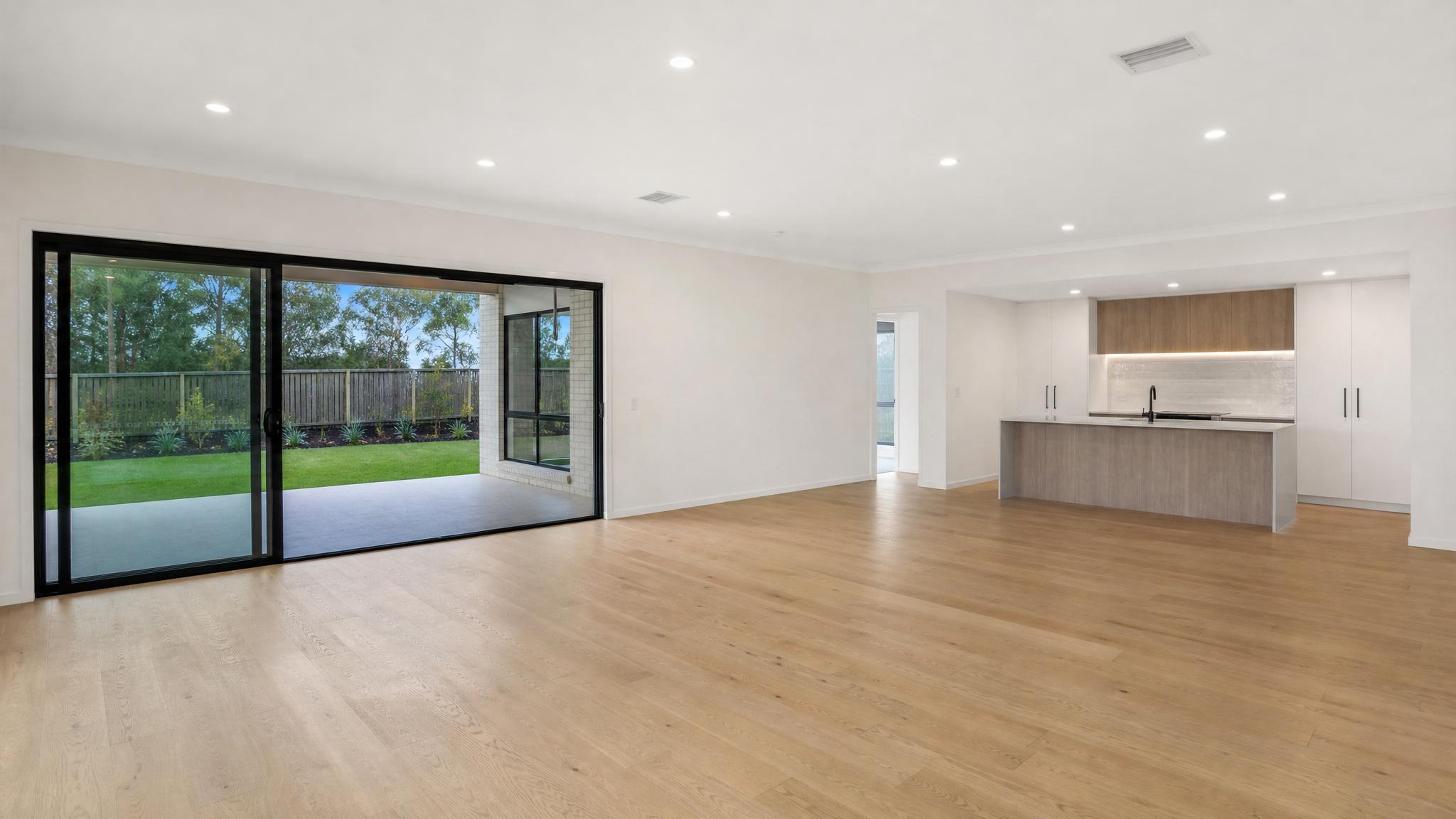 Before image of an empty open-plan living room.