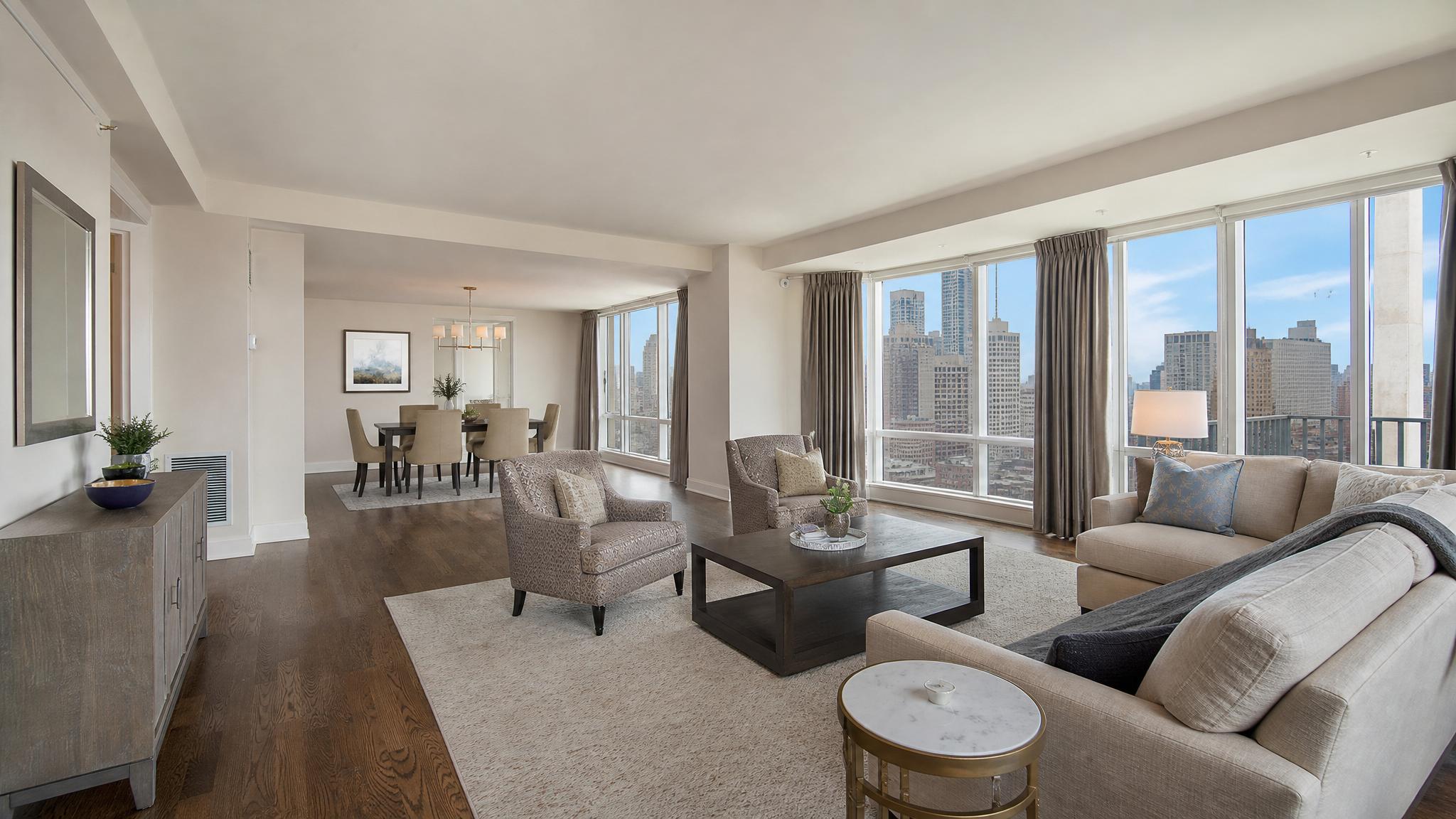 Before image of a transitional open-plan living room in a penthouse apartment.