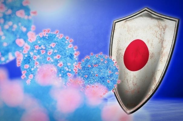 Particelle Virali di Covid-19 Colpiscono uno Scudo con la Bandiera del Giappone