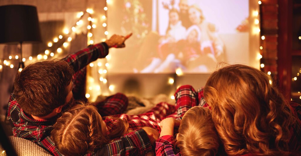 Famiglia che guarda un film di natale in atmosfera natalizia