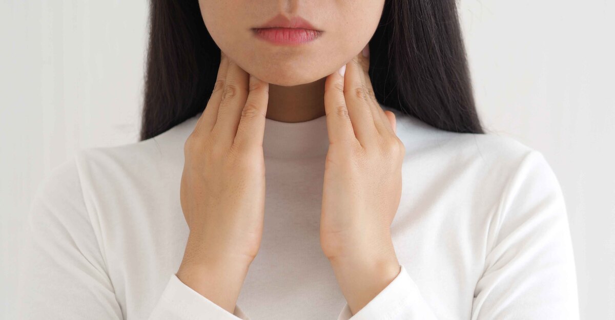 Donna sofferente si tocca il collo