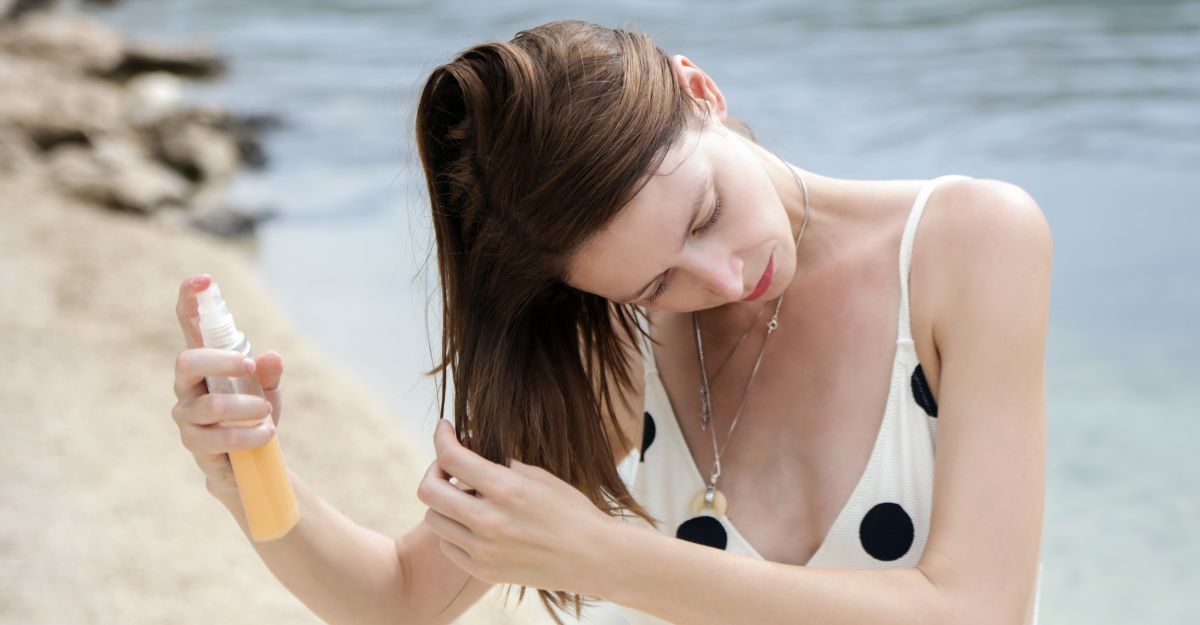 Ragazza applica spray sui capelli