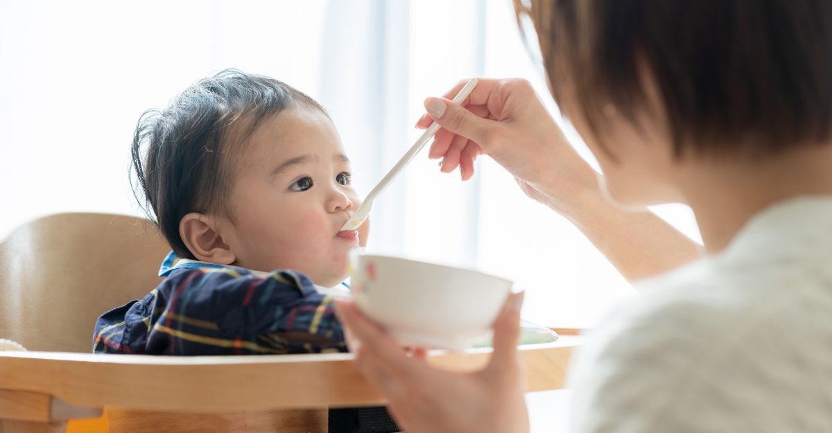 Bambino giapponese nutrito sul seggiolone