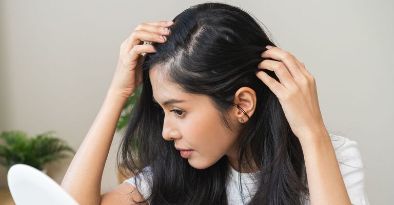 Ragazza che si controlla il cuoio capelluto