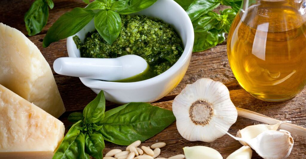 pesto alla ligure nel mortaio con aglio, olio, basilico e parmigiano