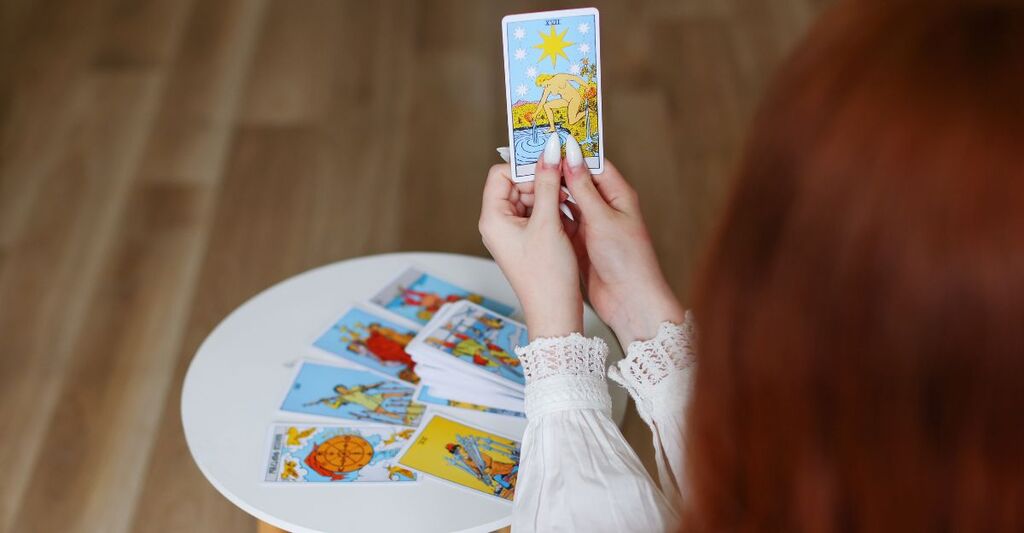 Carta dei tarocchi tenuta in mano in primo piano