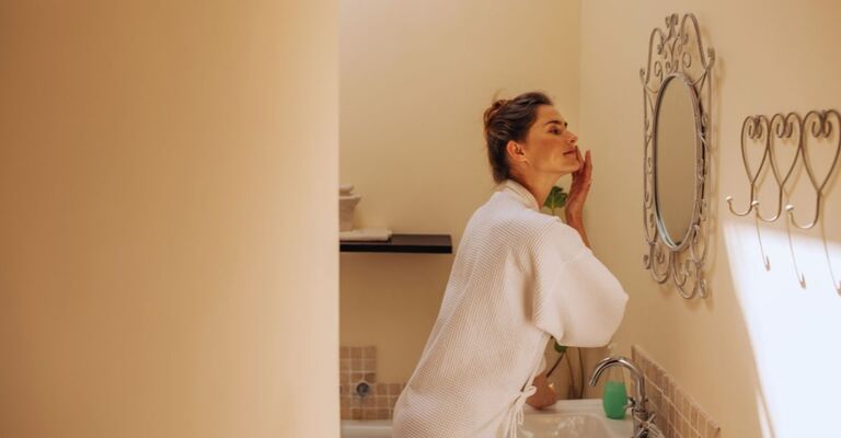 Donna che osserva la sua pelle allo specchio