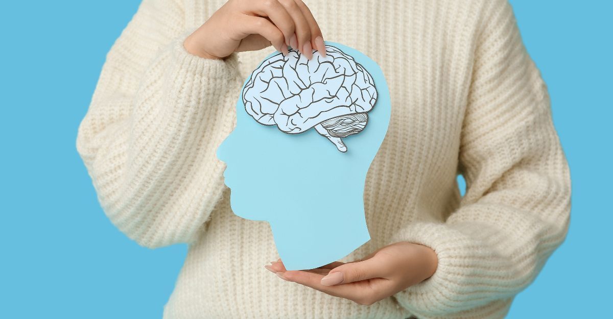 Una donna tiene in mano la stampa di un cervello.