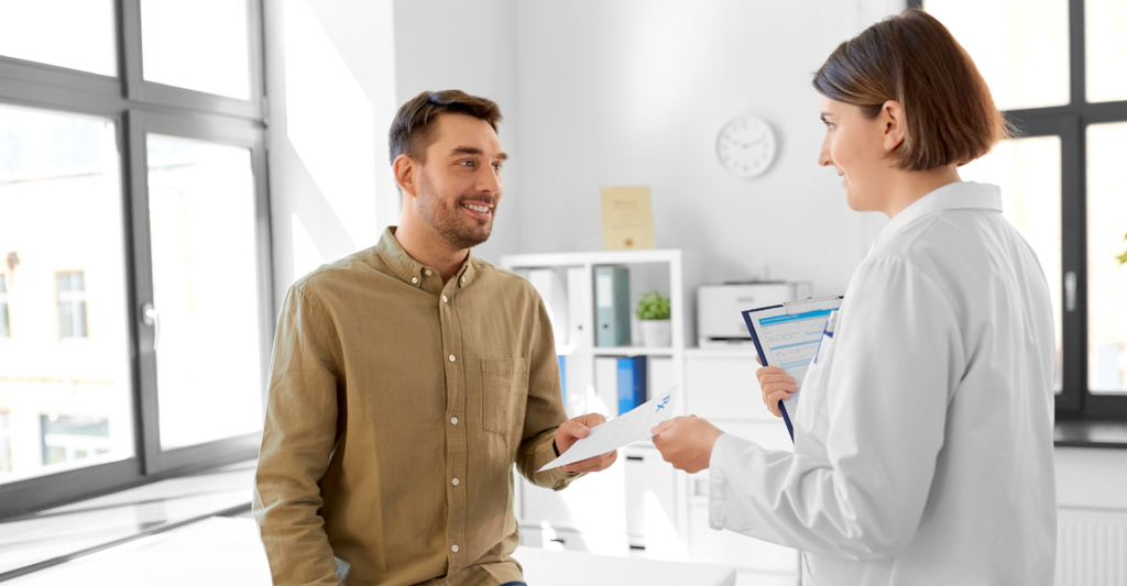 Medicina, assistenza sanitaria e concetto di persone - medico donna che dà la ricetta a un paziente in ospedale
