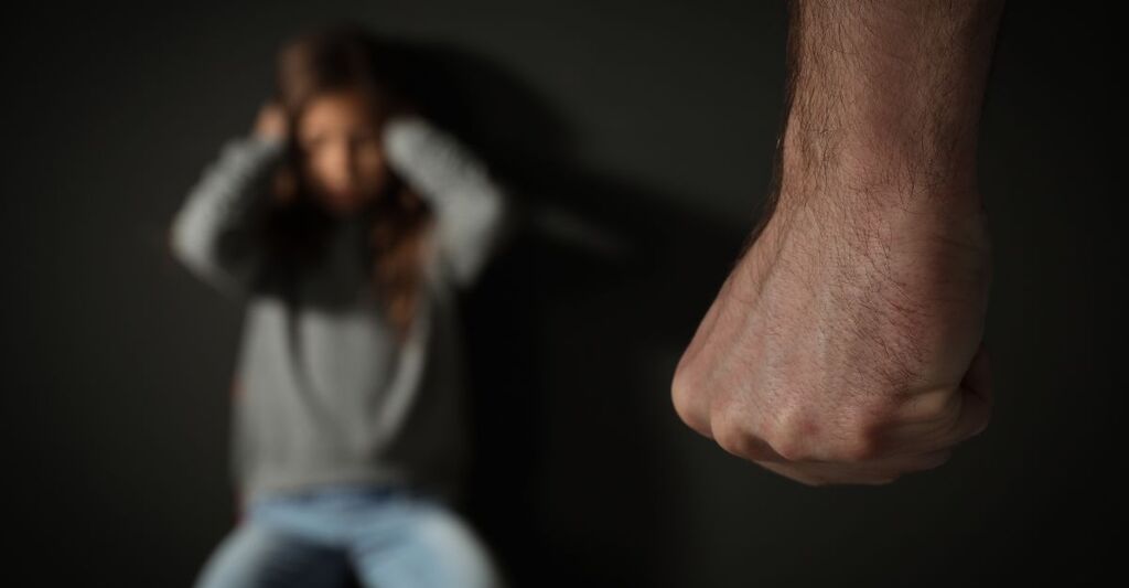 Un uomo che fa violenza su una donna.