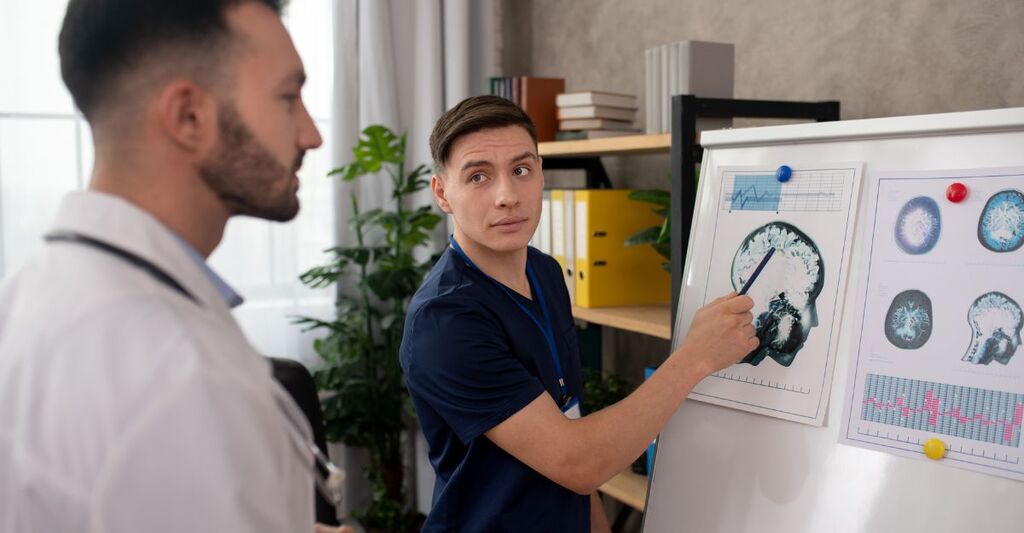 Due medici discutono davanti alla lastra di un cervello