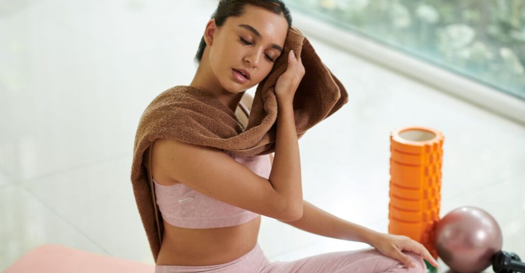 ragazza in palestra, si asciuga il sudore